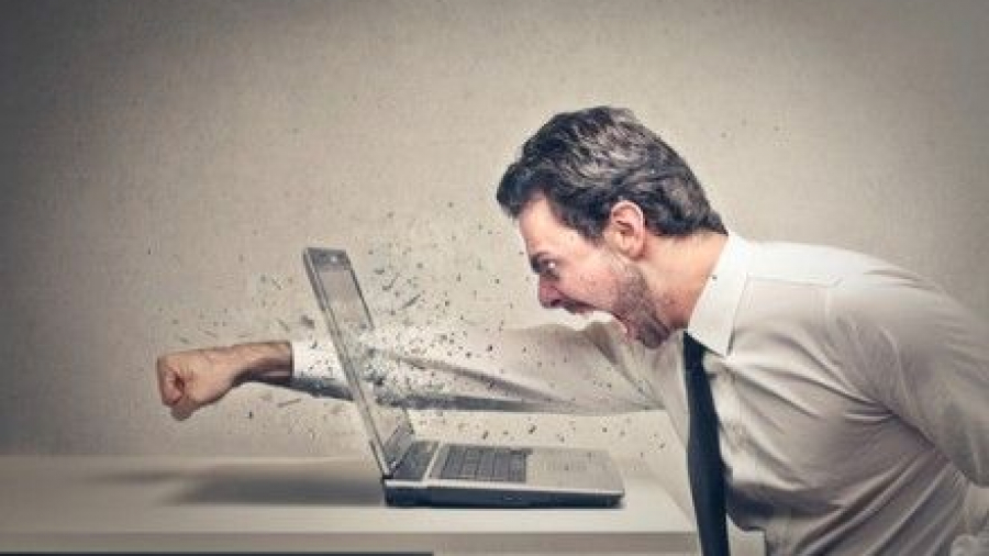 A man punching a laptop