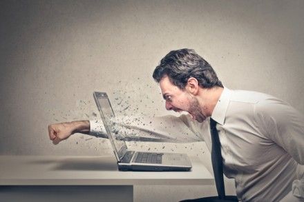 A man punching a laptop