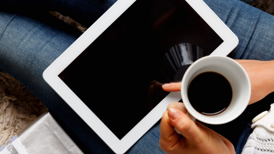 A cup of coffee and a tablet