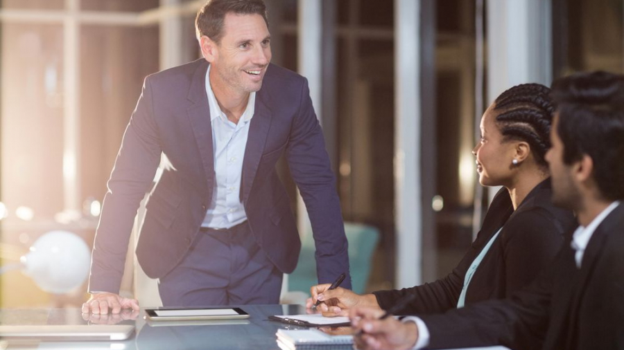 Businessman interacting with coworkers in a meeting in the conference room