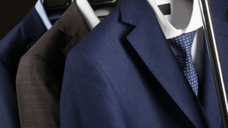 Elegant,Man's,Suits,Hanging,In,A,Row,-,Closeup,Shot