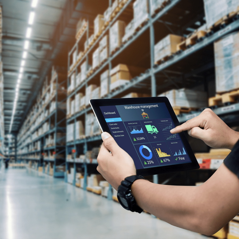 A warehouse automation worker guiding a pallet shuttle.