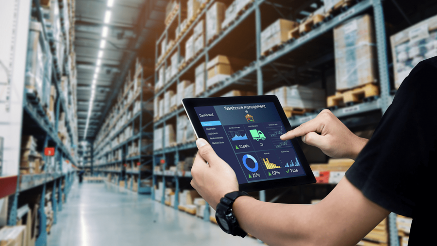 A warehouse automation worker guiding a pallet shuttle.