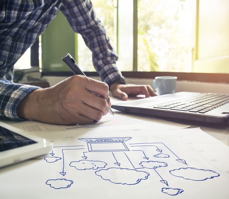 businessman creating diagram with pen and paper