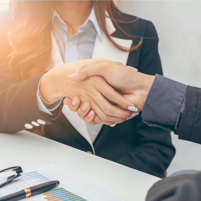 An enVista consultant shakes hands with an enVista partner.