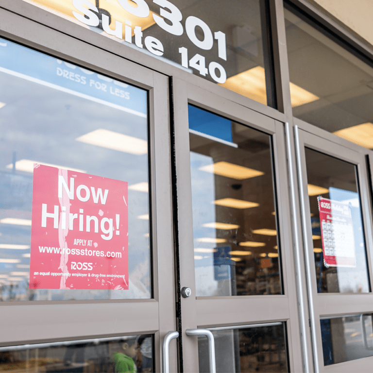 now hiring sign on retail door