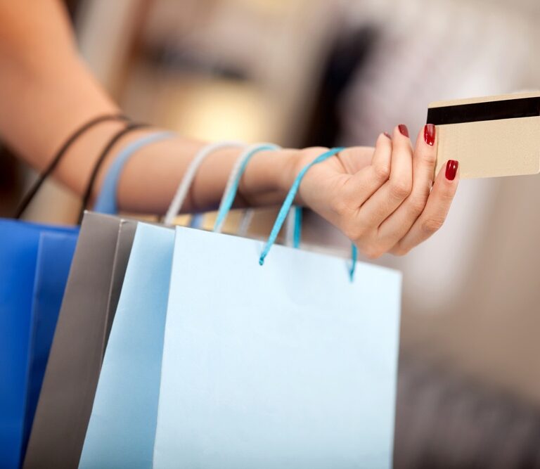 Woman shopping and paying with a debit or credit card