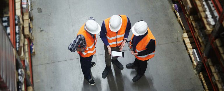 Warehouse workers using a tablet