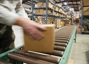 A package being placed on a conveyor belt