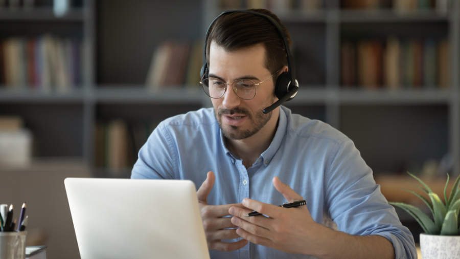 Confident,Man,Teacher,Coach,Wearing,Headset,Speaking,,Holding,Online,Lesson,