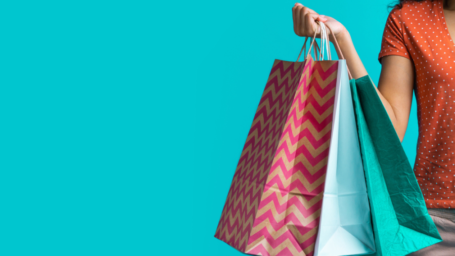 Cropped,Shot,Of,Female,Hand,Holding,Three,Paper,Shopping,Bags