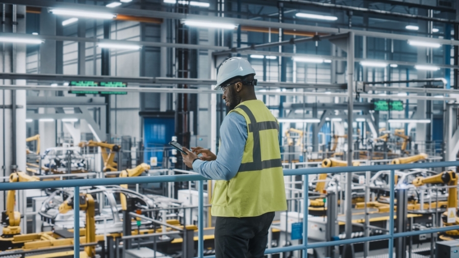African,American,Car,Factory,Engineer,In,High,Visibility,Vest,Using
