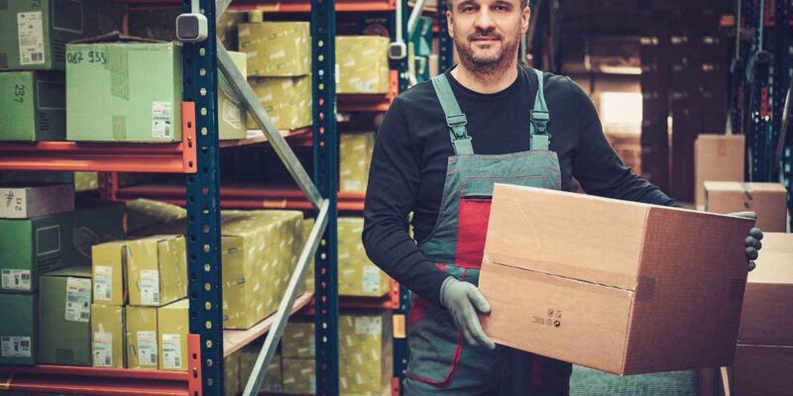A man holding a box in a warehouse