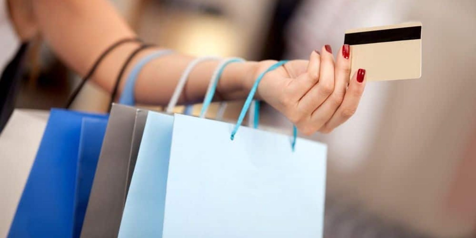 Woman shopping and paying with a debit or credit card
