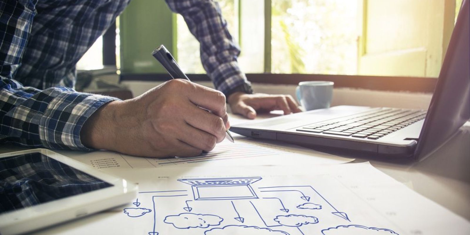 businessman creating diagram with pen and paper