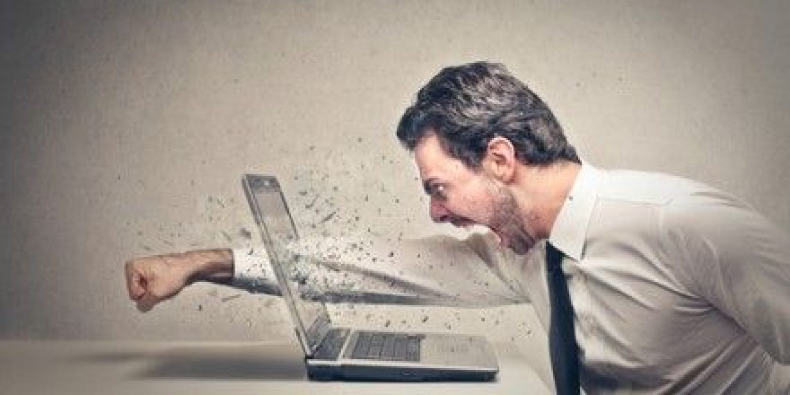 A man punching a laptop