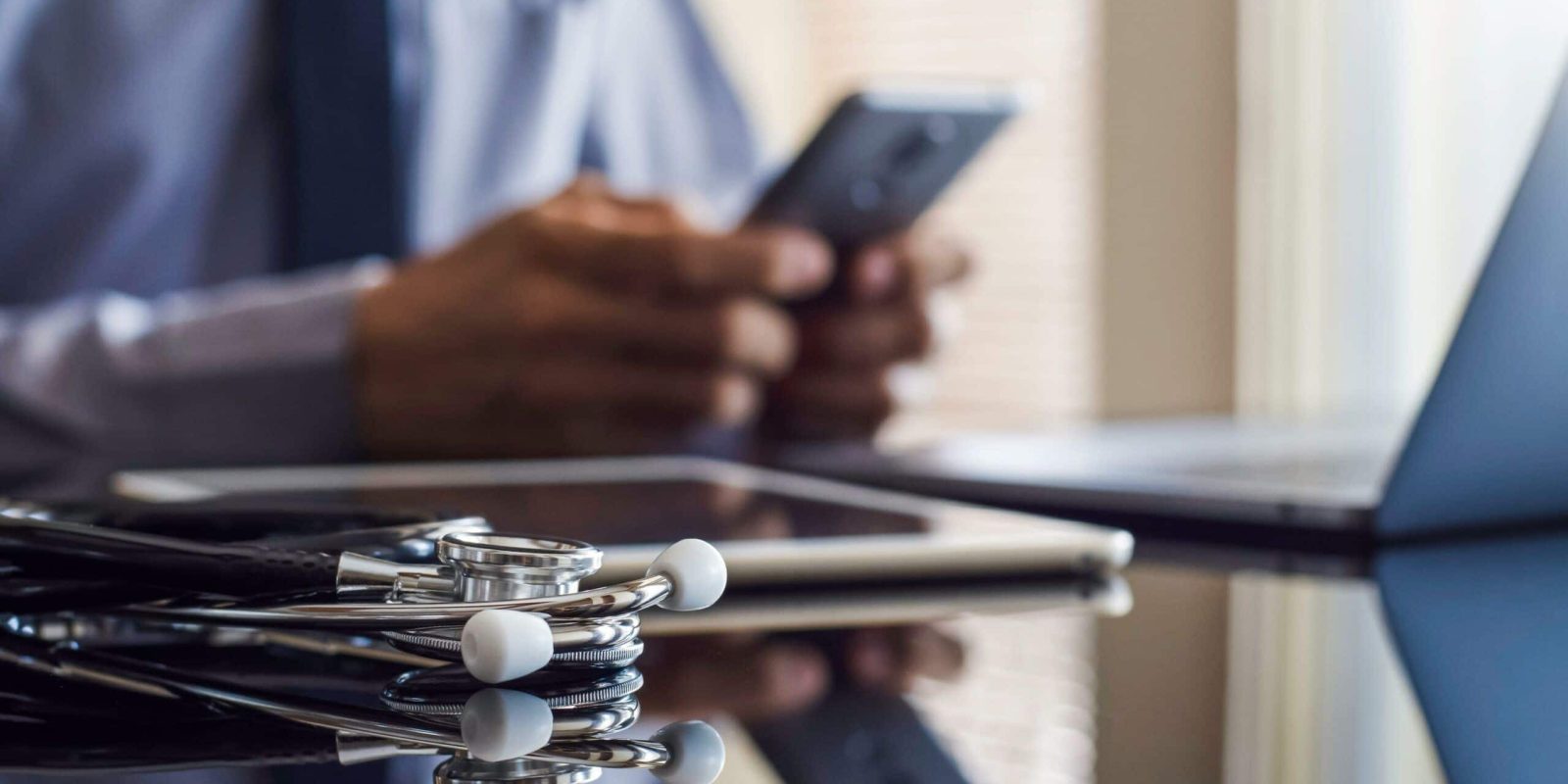 A doctor using telehealth through his phone