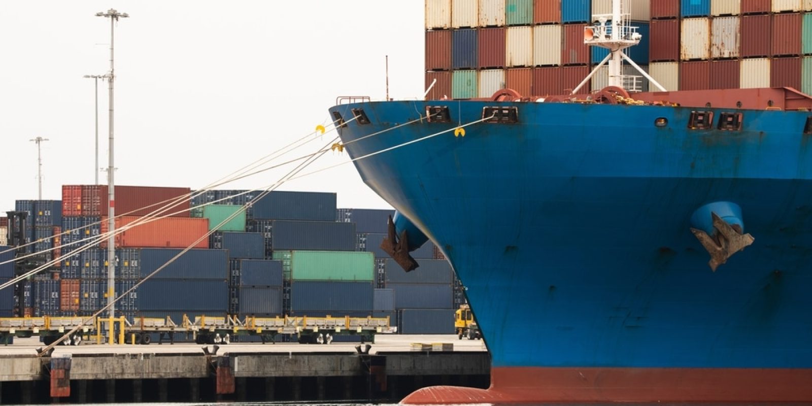 A,Cargo,Vessel,Full,Of,Containers,Sits,Docked,At,Port.