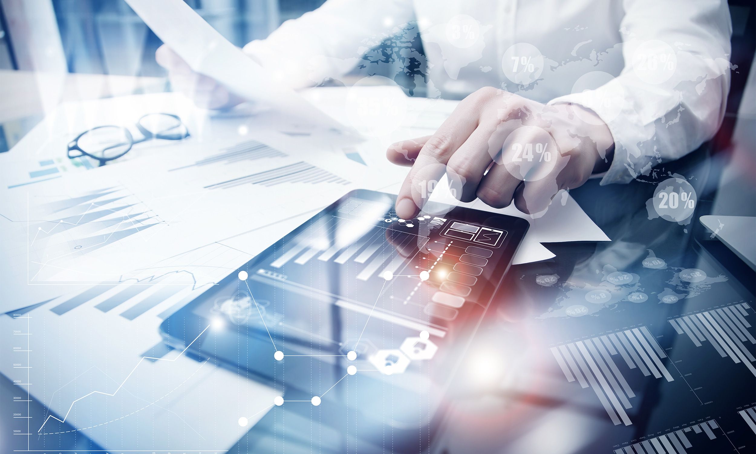 A person reviews financial reports and graphs on paper and a tablet, with data and analytics icons overlaid, suggesting business analysis enhanced by innovative technology solutions.