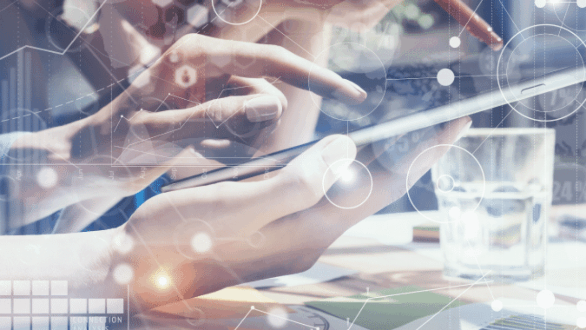 Two people use digital tablets at a desk with documents and a glass of water. Abstract technology and data icons overlay the image, symbolizing innovation, teamwork, and digital collaboration in a modern workspace.