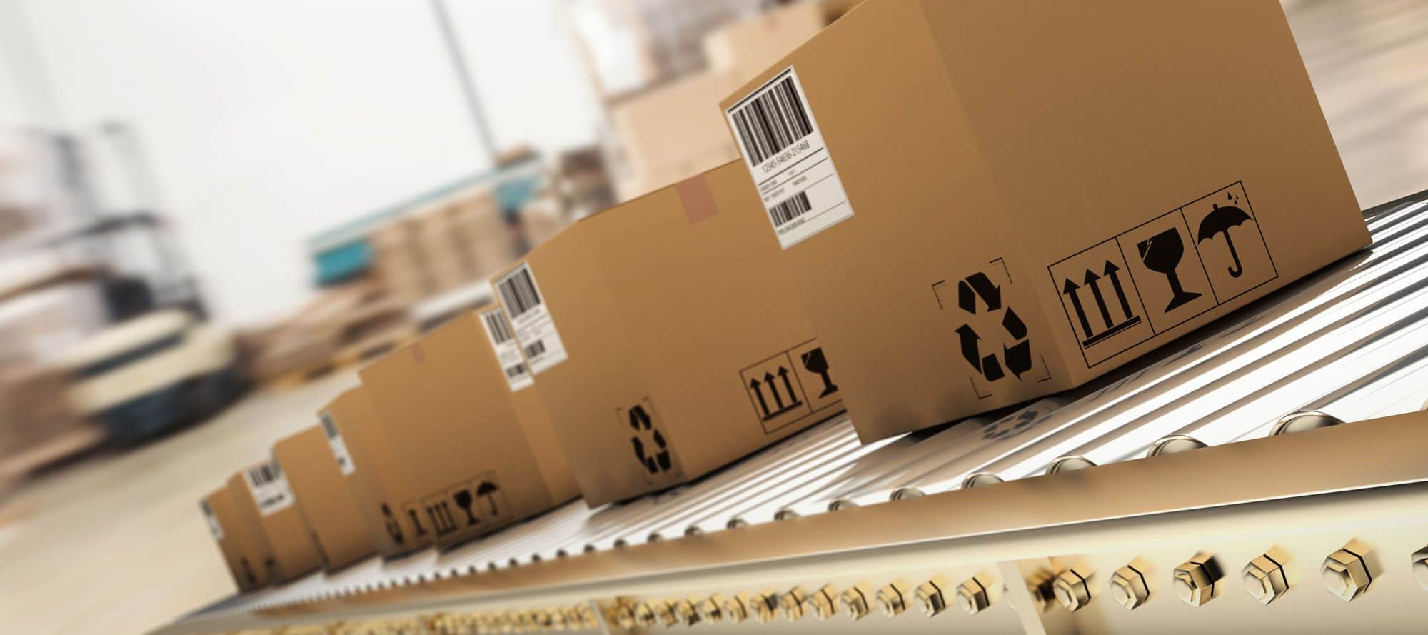 Several cardboard boxes with barcodes and shipping symbols move along a conveyor belt in a warehouse or distribution center, suggesting a shipping or logistics process.