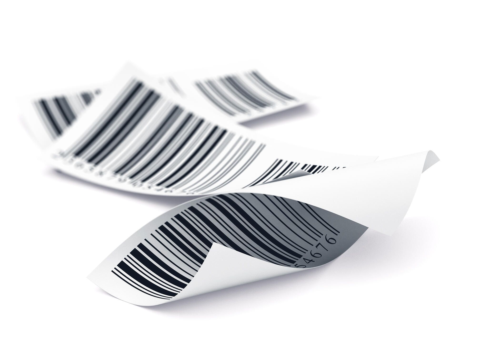 Traceability Three curled, white paper receipts with black barcodes are lying on a white surface, overlapping slightly.