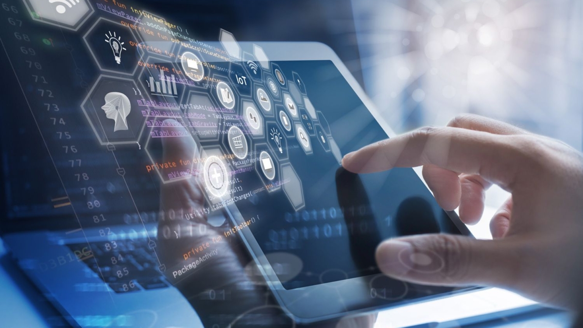 A person interacts with a tablet displaying digital icons and data graphics, with a futuristic interface overlay representing technology, cloud computing, and artificial intelligence concepts.