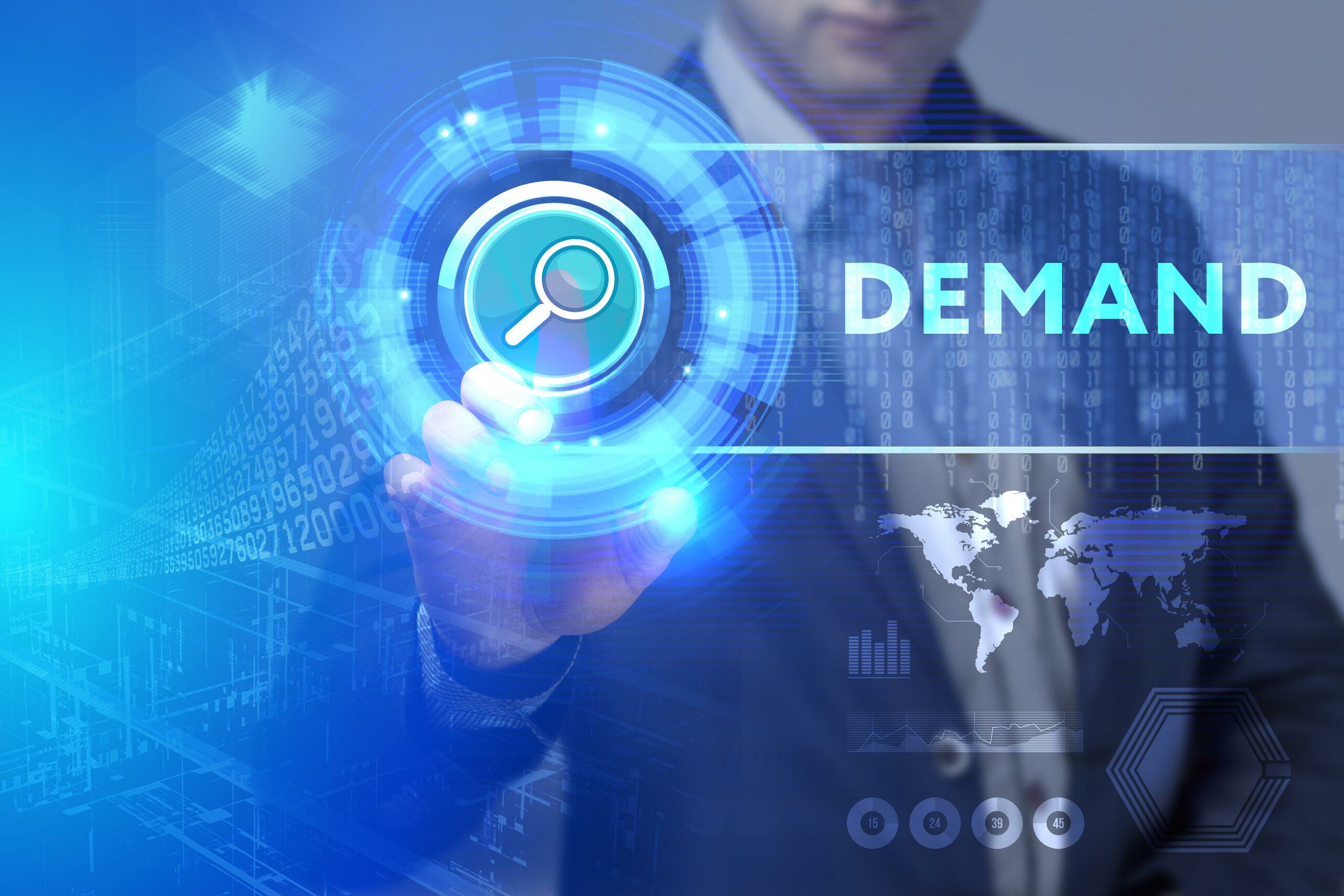 shutterstock_601569314 A person in a suit touches a digital search icon on a virtual interface, with the word DEMAND and graphics of data, world maps, and technology in the background.