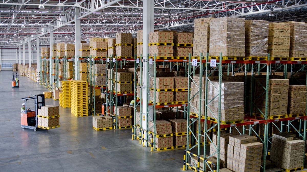 A warehouse with boxes on shelves, efficiently organized by staff working under an incentive based pay system.
