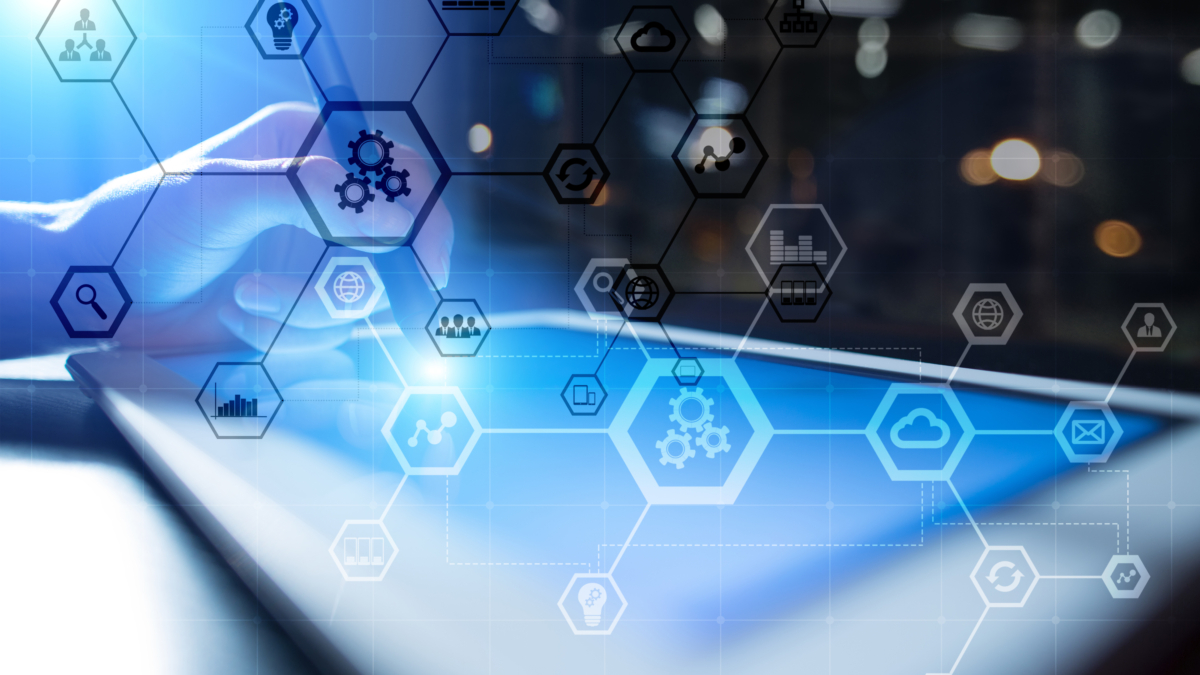 A person uses a stylus on a tablet with overlaid hexagonal icons representing technology, cloud computing, and data management, against a blurred background with blue and white lighting.