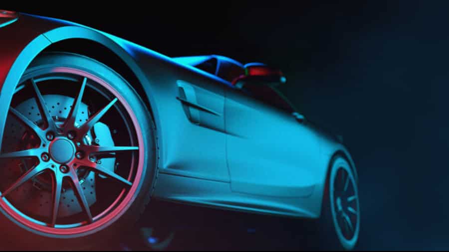 image – 2025-04-09T155916.069 Close-up, low-angle view of a sleek, modern sports car with dramatic blue and red lighting highlighting the rear wheel, brake discs, and smooth side body—an image embodying the precision of advanced automation strategies against a dark background.