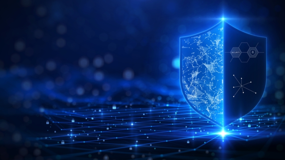 A glowing digital shield with network and security icons stands on a futuristic grid, symbolizing cybersecurity, Microsoft application management, and data protection on a blue tech-themed background.