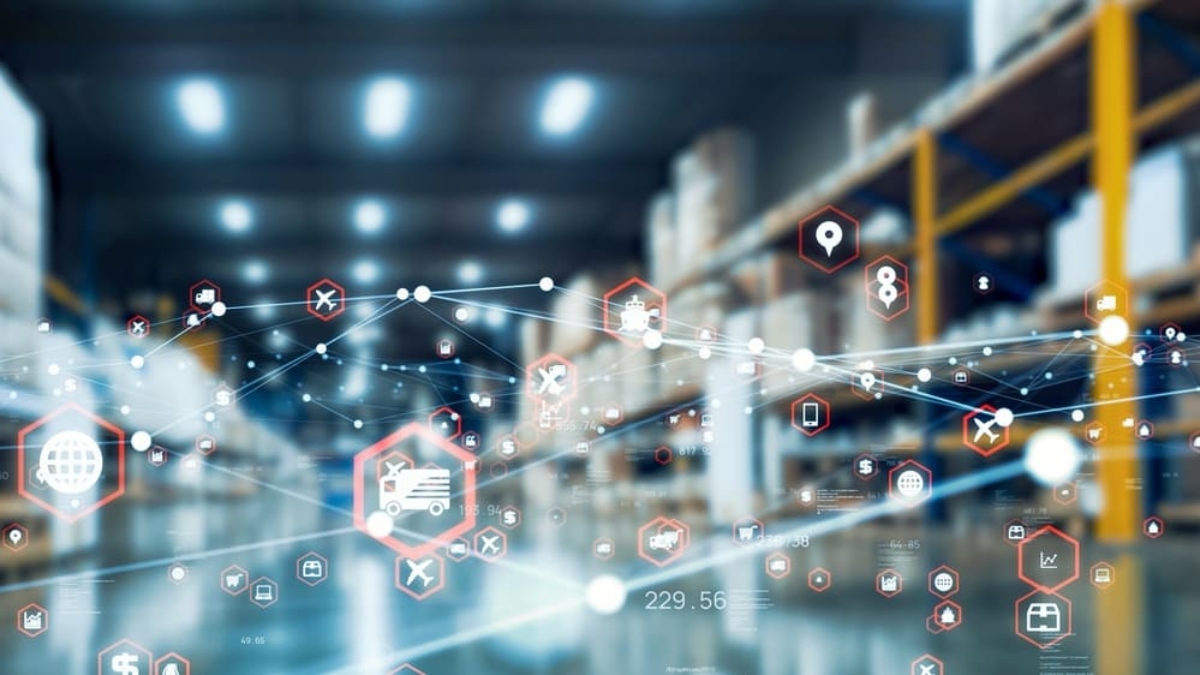 A blurred warehouse with shelves filled with boxes, overlaid by digital network icons representing technology and connectivity, symbolizing smart warehouse automation and effective supply chain strategy.