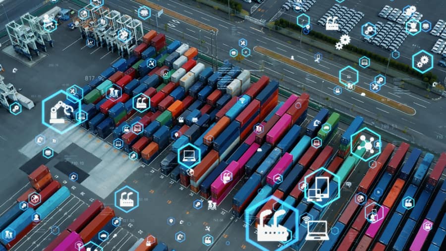 Aerial view of a shipping container yard with colored containers and overlayed digital icons representing technology, automation, and connectivity in logistics and supply chain management.
