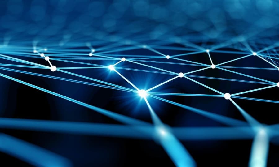 A digital network of glowing blue lines and nodes against a dark background, symbolizing connectivity and data exchange. The image has a futuristic and abstract appearance.