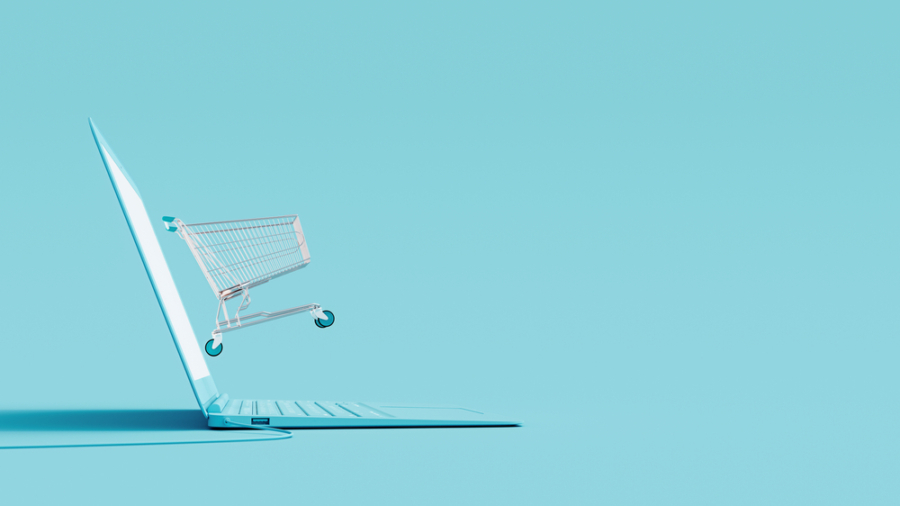 Online,Shopping,Concept.,Laptop,And,Shopping,Cart,On,Blue,Background