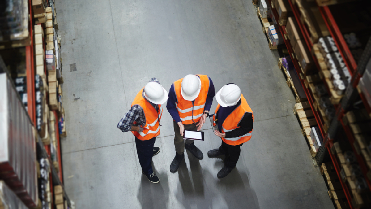 Team,Of,Warehouse,Workers,With,Touchpad,Making,Revision,Of,Goods