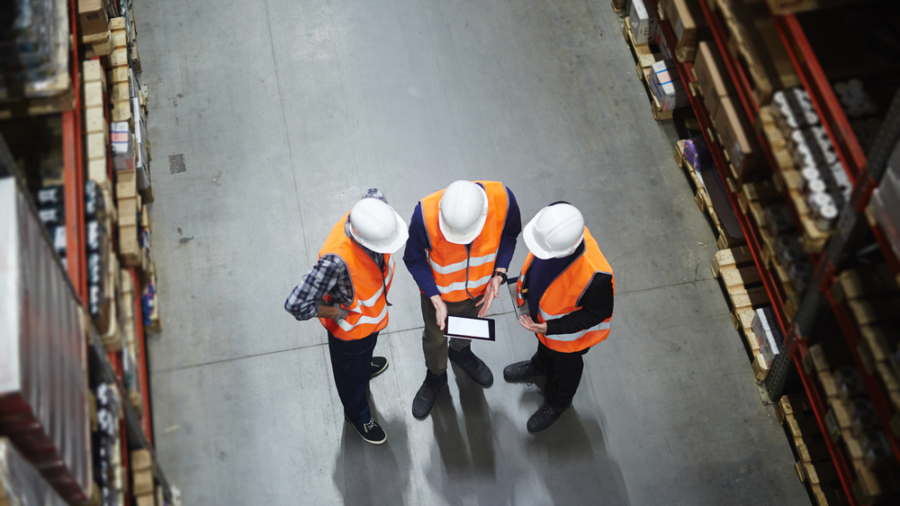 Team,Of,Warehouse,Workers,With,Touchpad,Making,Revision,Of,Goods