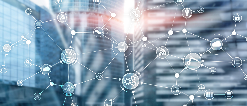 Abstract image of interconnected digital icons, such as gears, cloud, lock, and shopping cart, overlaid on a blurred cityscape of modern glass buildings, symbolizing network, technology, communication concepts, and supply chain planning.