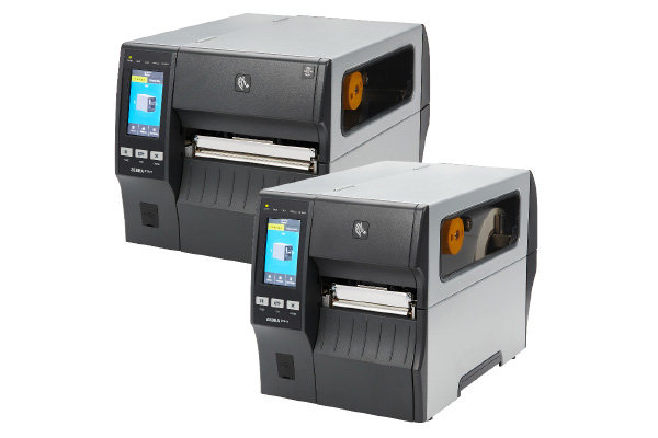 Two gray industrial label printers featuring color touchscreens and visible label rolls inside, positioned side by side at an angle on a white background—designed for efficiency with integrated mobile & edge technology.