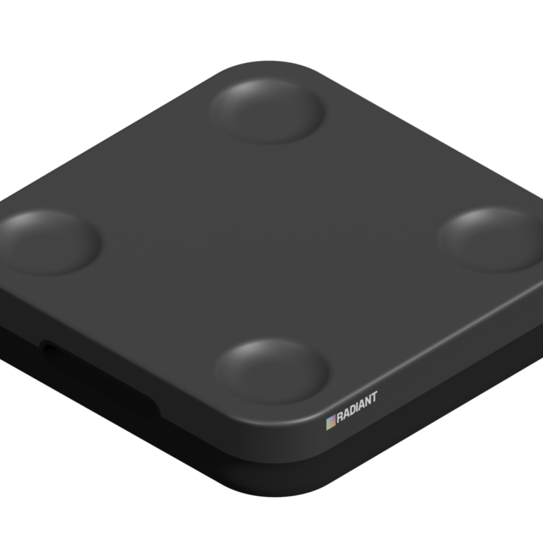 A black, square-shaped pick-to-light device with rounded corners and four circular indents on its surface, featuring a small logo and colored square near one edge, is shown against a plain white background.