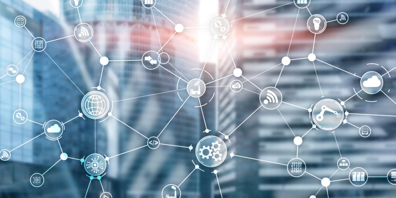 Abstract image of interconnected digital icons, such as gears, cloud, lock, and shopping cart, overlaid on a blurred cityscape of modern glass buildings, symbolizing network, technology, communication concepts, and supply chain planning.