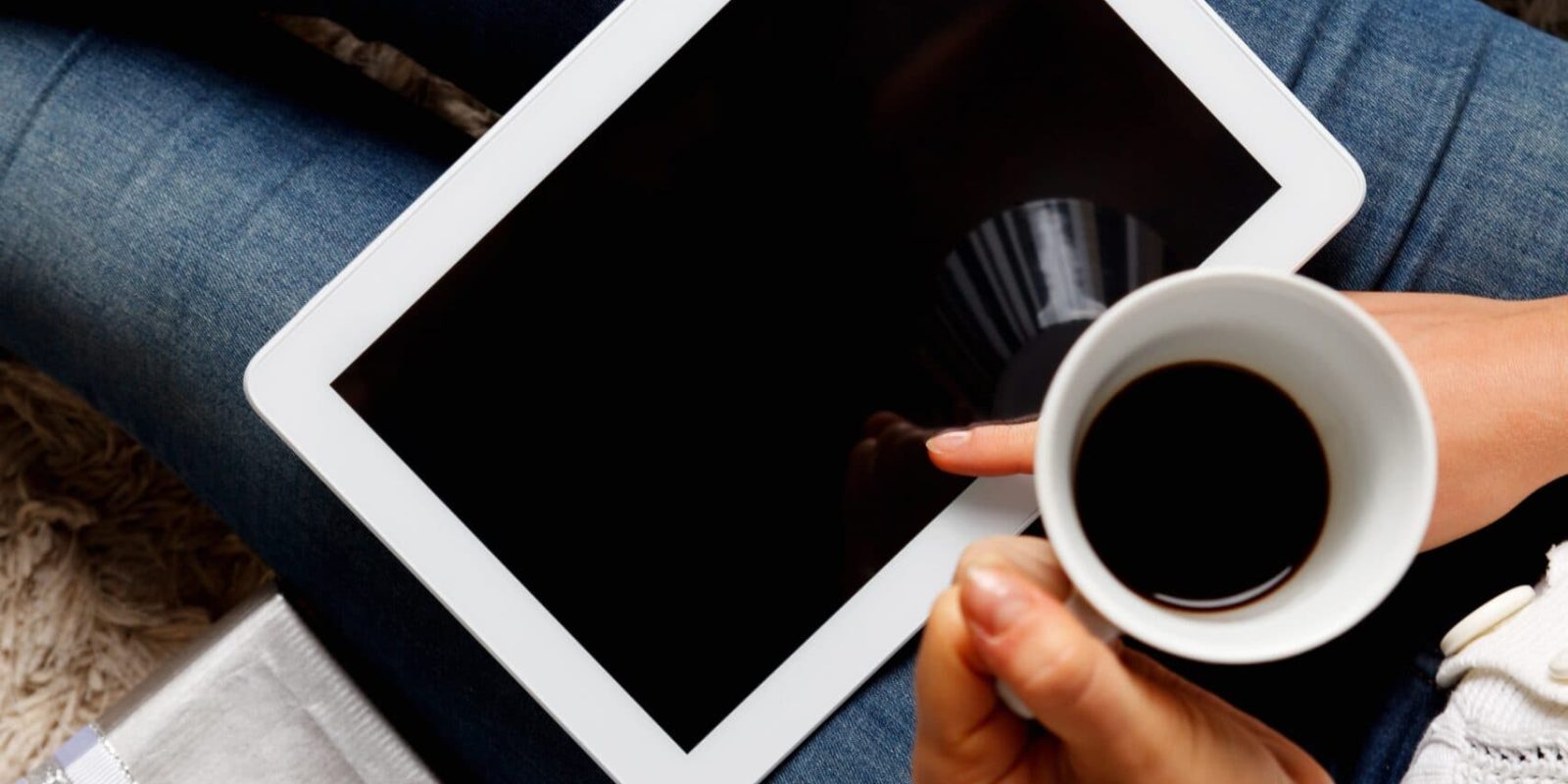 A cup of coffee and a tablet