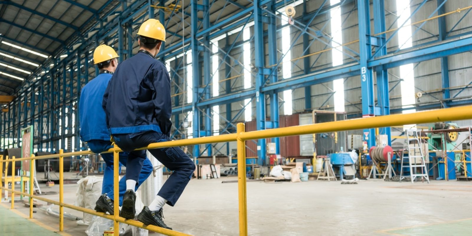 Rear,View,Of,Two,Blue-collar,Workers,During,Break,In,The